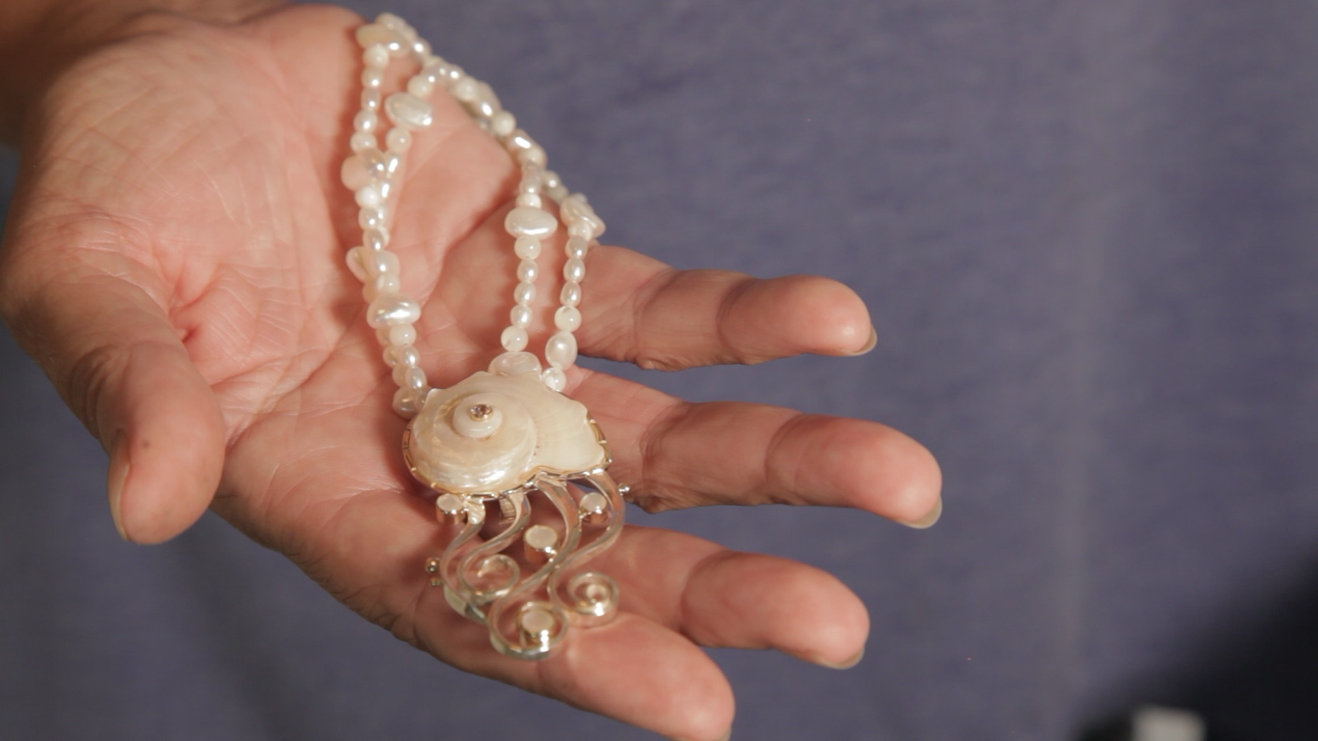 Barbara Holding a Seashell Pendent