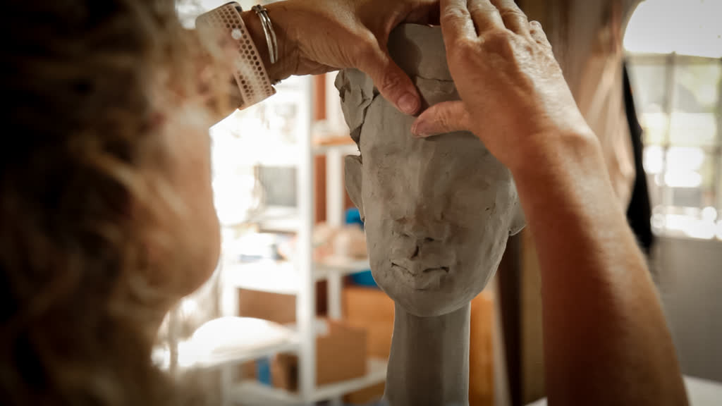 Julie Sculpting a Face in her Studio